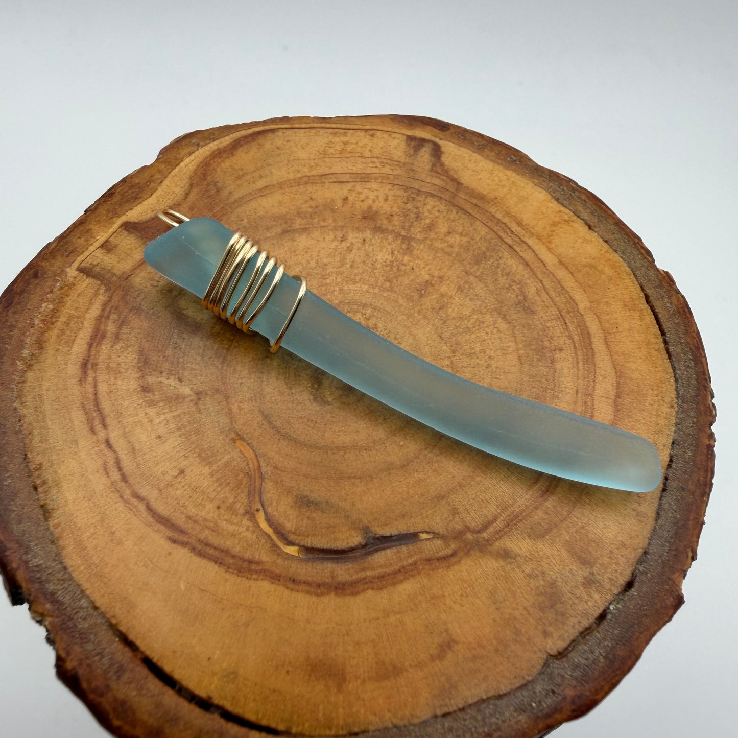 Light Blue Tumbled Glass Pendant with Gold Tone Wire