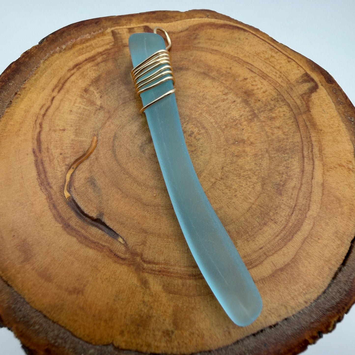 Light Blue Tumbled Glass Pendant with Gold Tone Wire