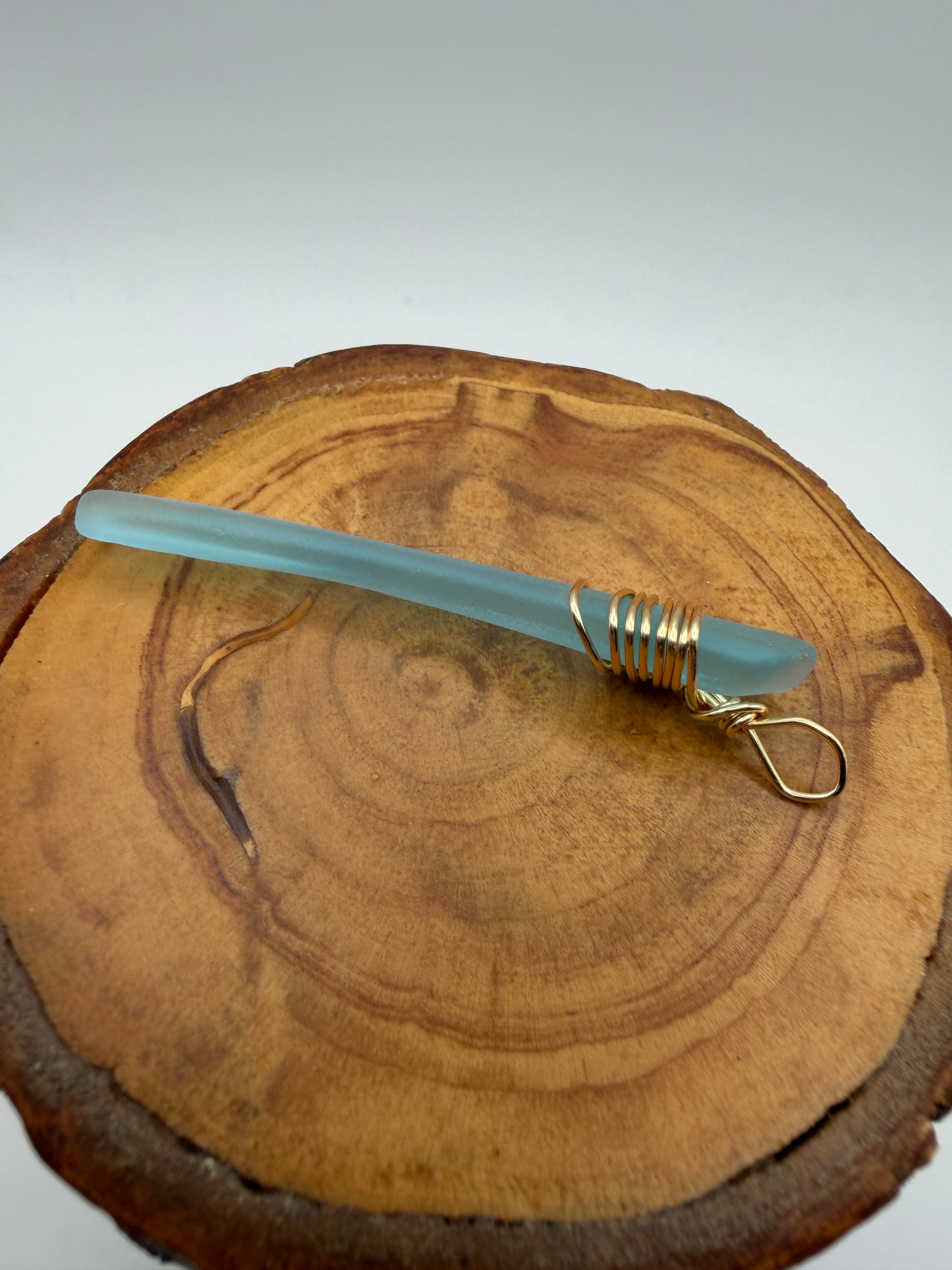 Light Blue Tumbled Glass Pendant with Gold Tone Wire